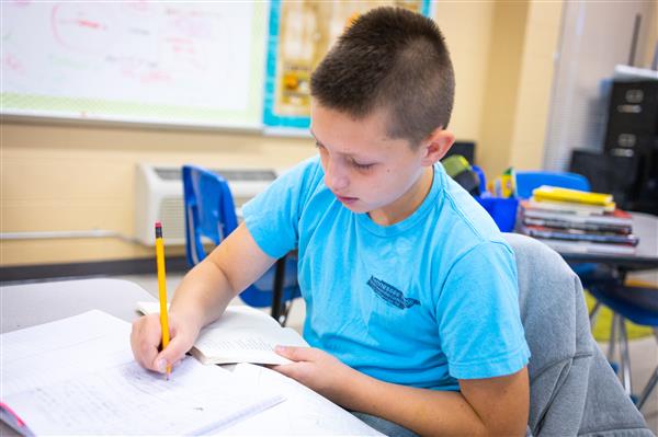 Students inside their classrooms learning. 